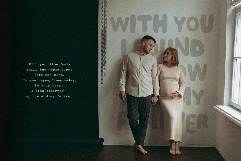 Man and woman standing in a room with quirky text on the wall.
