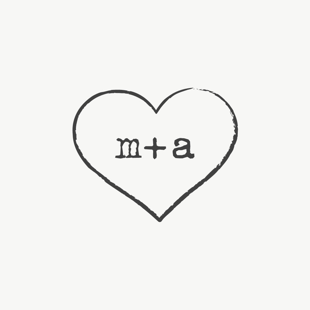Custom wedding stamp featuring a heart design with couple’s initials in a typewriter font