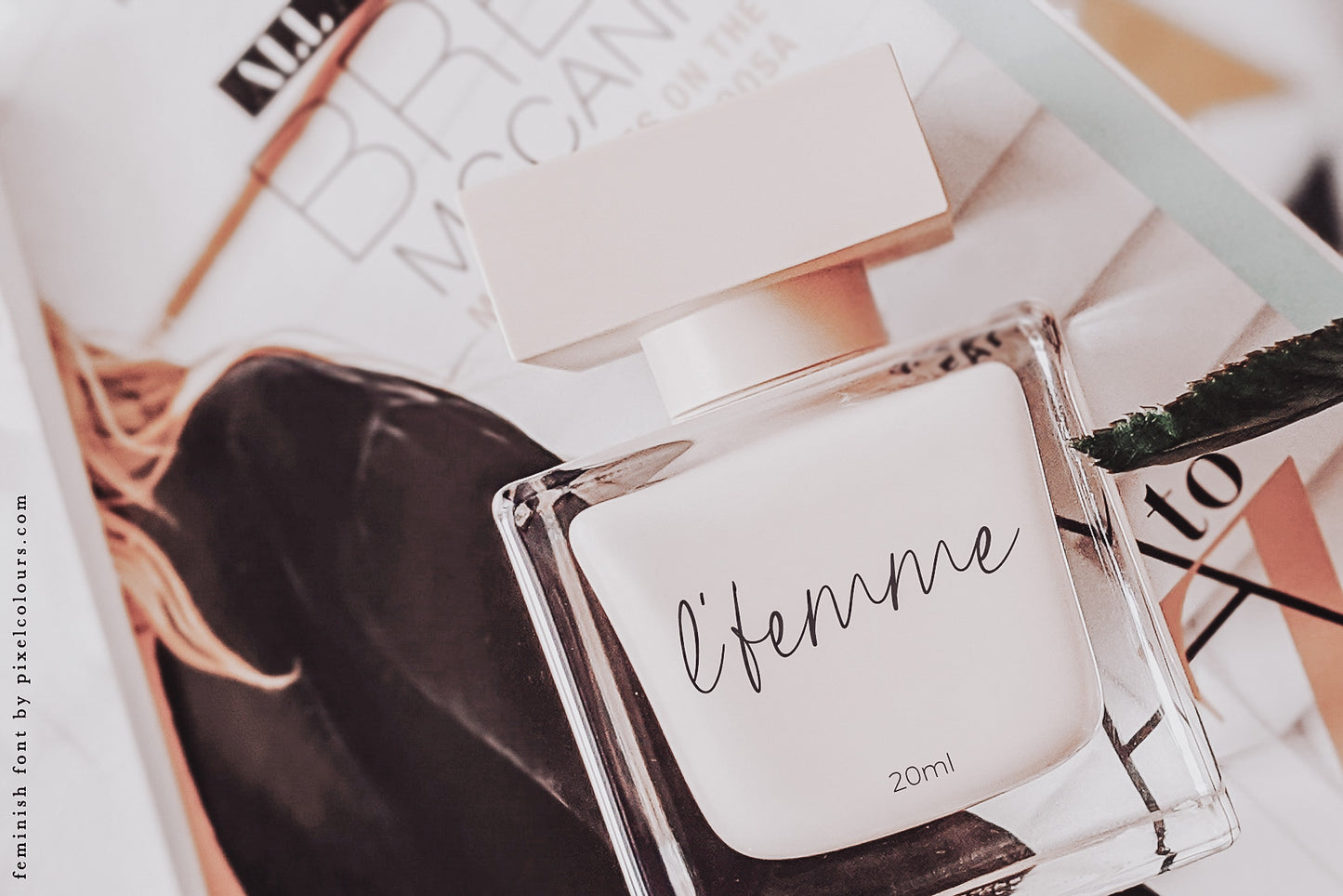Perfume bottle mockup featuring feminine handwritten script font, available for free download