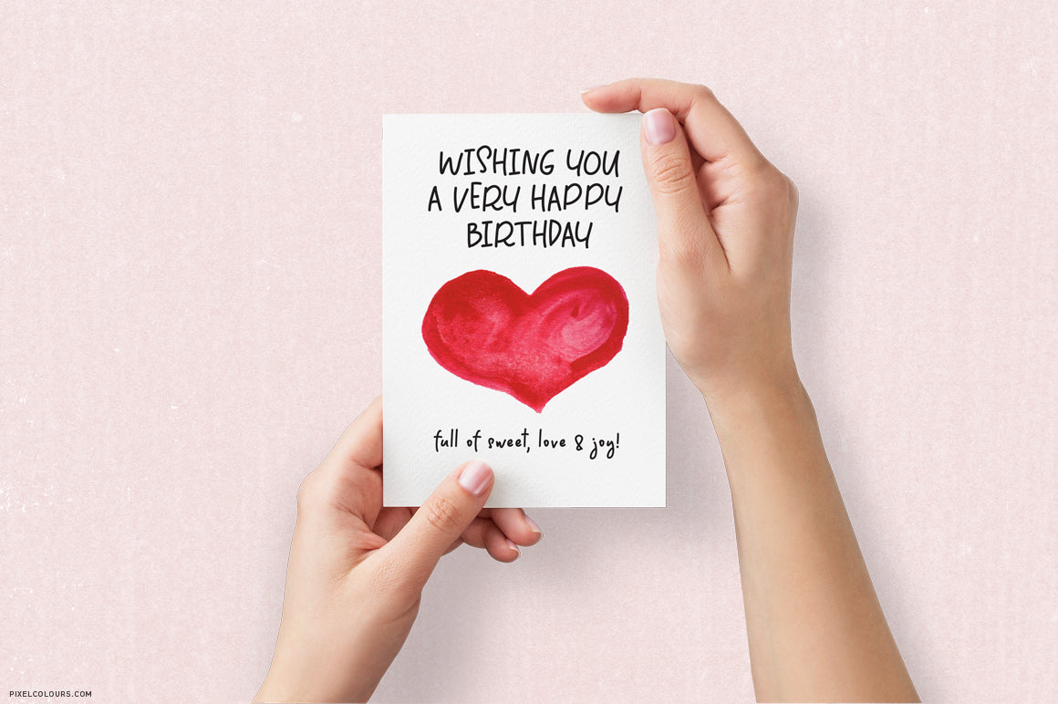 Birthday greeting card in hands mockup featuring handwritten font with natural flow, available for free download