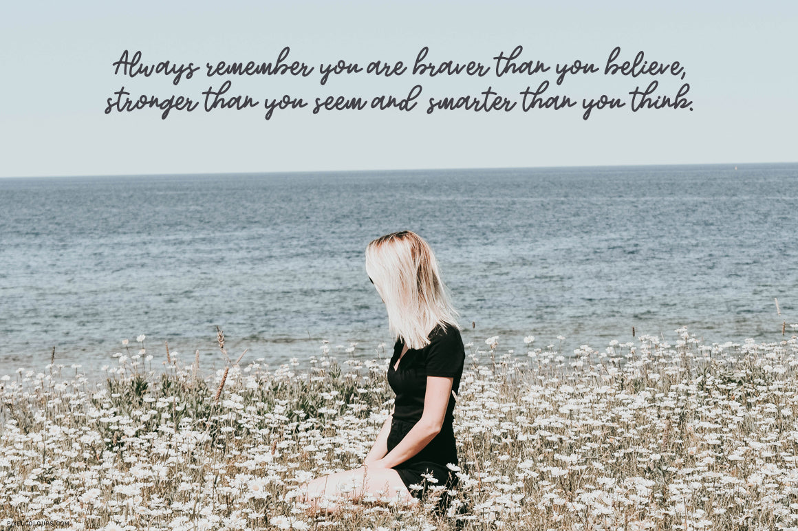 Woman looking the sea with self confidence quote featuring monoline script font with a bouncy baseline, available for free download