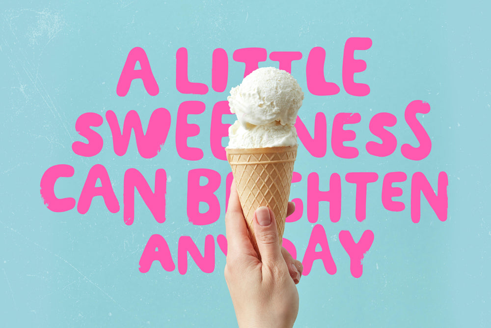 Ice cream cone held by a hand with pink sweet quote on a light blue background