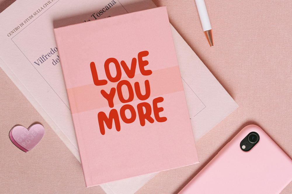 Pink card with 'LOVE YOU MORE' text written with playful font