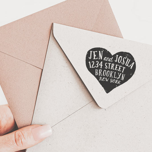 Return address stamp featuring a heart design and personalized text in a handwritten fonts