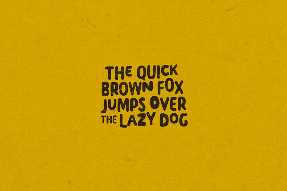 Pangram 'The quick brown fox jumps over the lazy dog' on a mustard yellow background