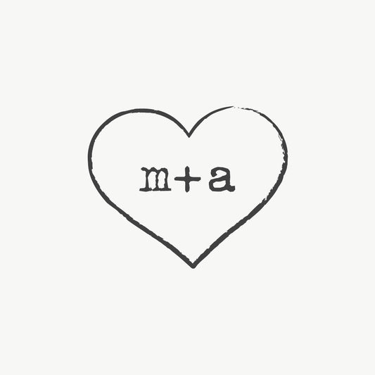Custom wedding stamp featuring a heart design with couple’s initials in a typewriter font
