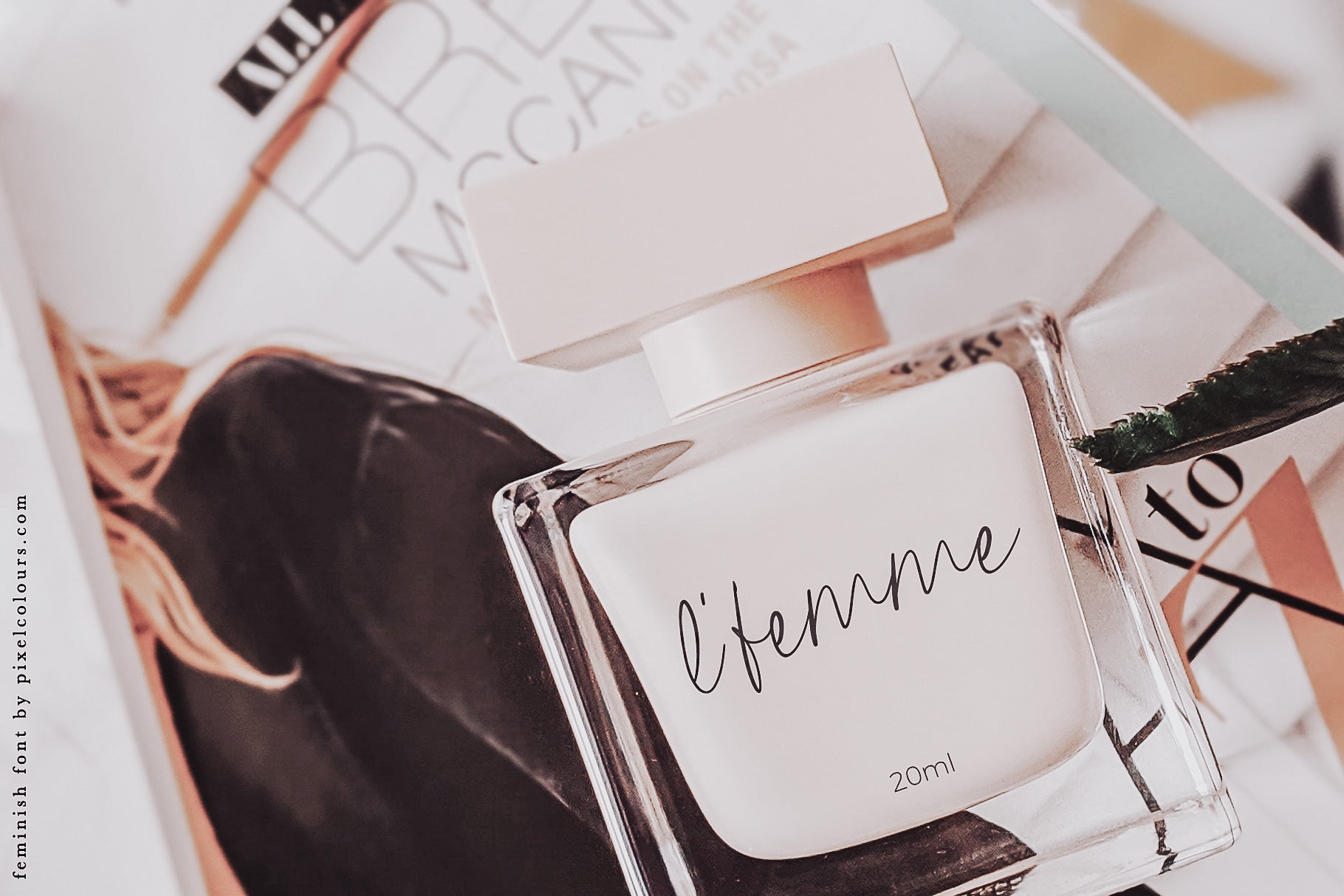 Perfume bottle mockup featuring feminine handwritten script font, available for free download