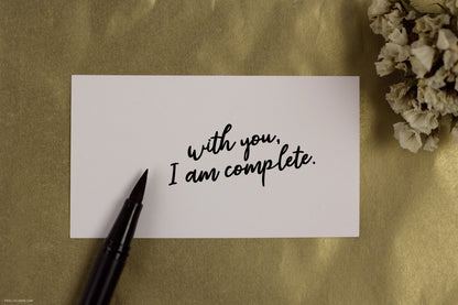 Card mockup with Tombow brush pen featuring handwritten font with a playful style, available for free download