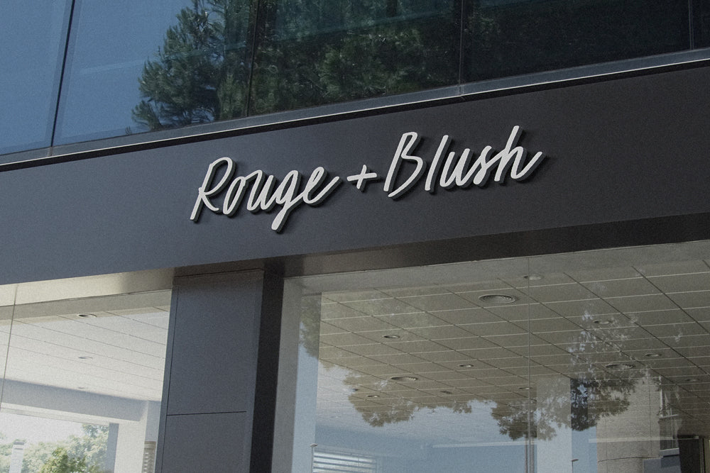 3D sign reading "Rouge and Blush" displayed on the front of a chic, stylish storefront
