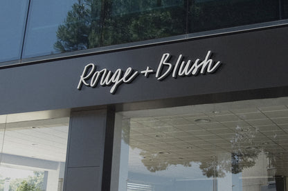 3D sign reading "Rouge and Blush" displayed on the front of a chic, stylish storefront
