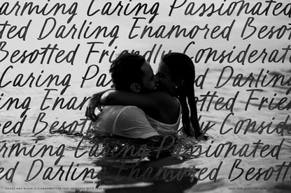 Couple kissing in the sea featuring love words in handwriting script font