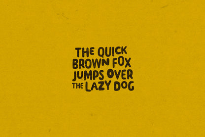 Pangram 'The quick brown fox jumps over the lazy dog' on a mustard yellow background