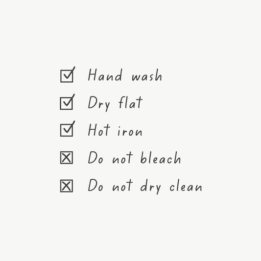 Care instructions stamp featuring text for washing, drying, and ironing in a simple, clear design with checkmarks